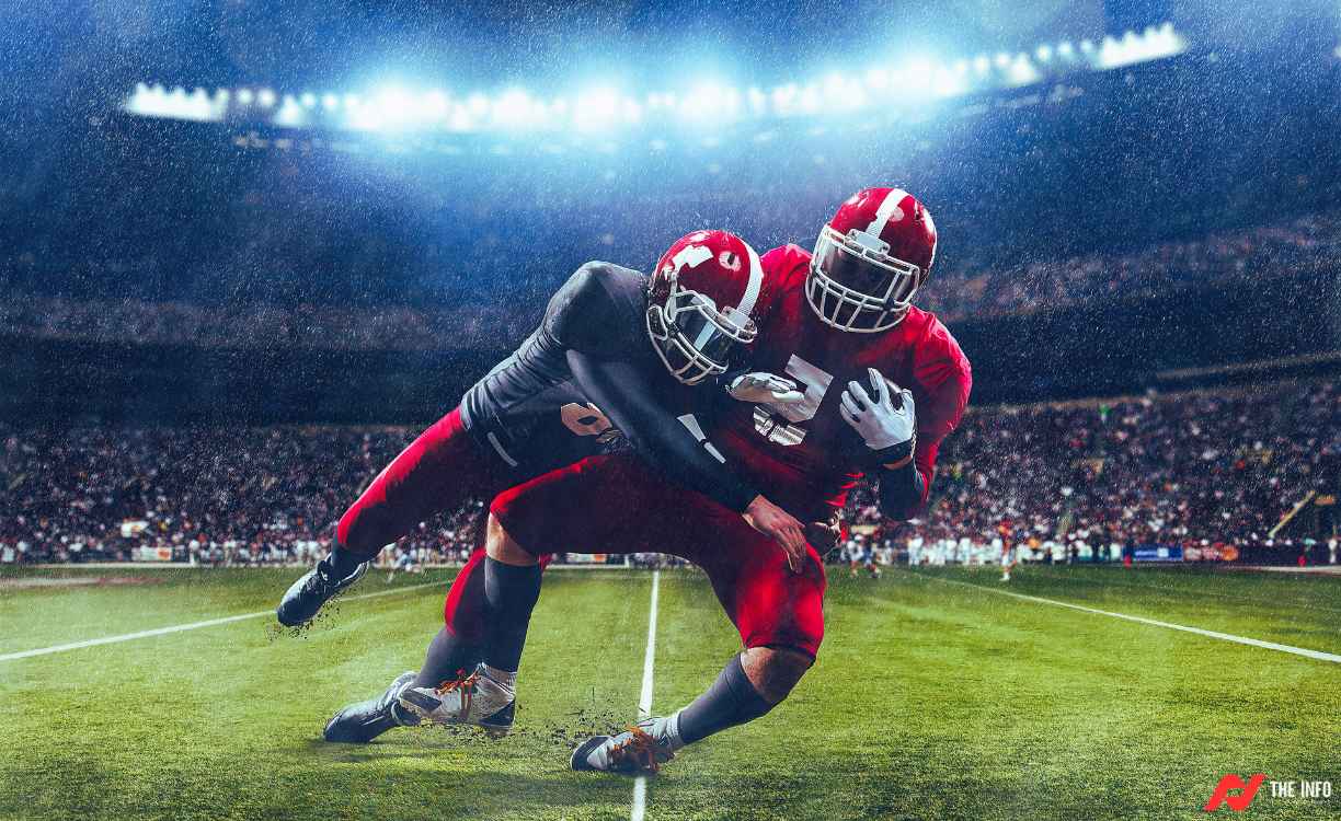 A football player catches a pass and runs for a first down.