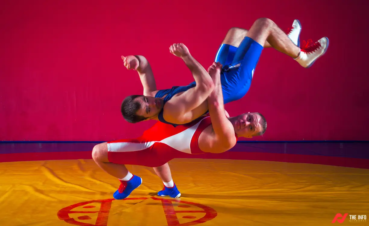 A wrestler executes a powerful suplex, sending their opponent crashing to the mat.