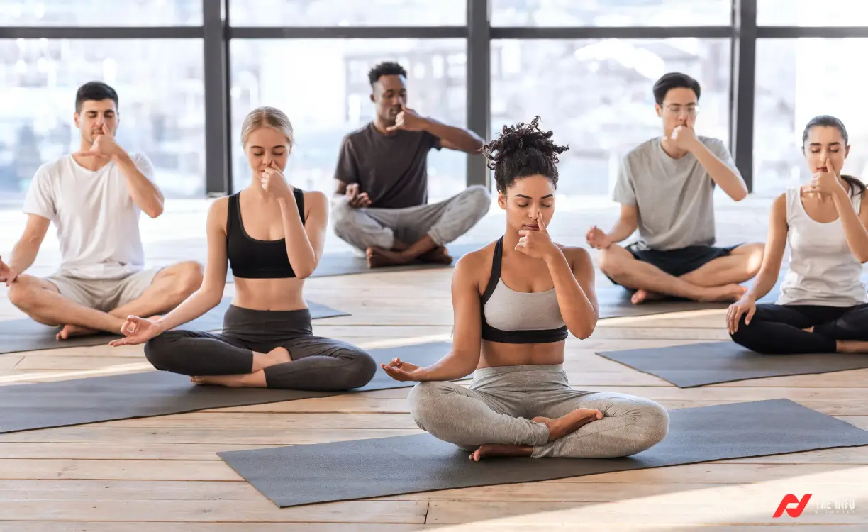 Yoga Breathing Exercises for Beginners: Some women sitting cross-legged on a yoga mat, practicing deep breathing with closed eyes and a calm expression.
